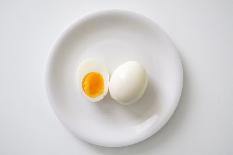 半分にカットされたゆで卵が白い皿に乗っている画像